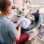 Higiena jamy ustnej – Fundament zdrowego uśmiechu 5 dentist examining woman teeth with diagnostic microscope 651396 2214