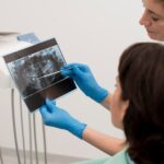 female patient looking radiography her teeth with dentist 23 2148985762