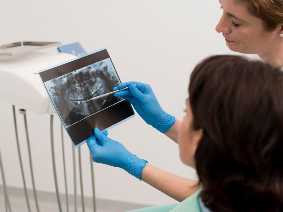 female patient looking radiography her teeth with dentist 23 2148985762